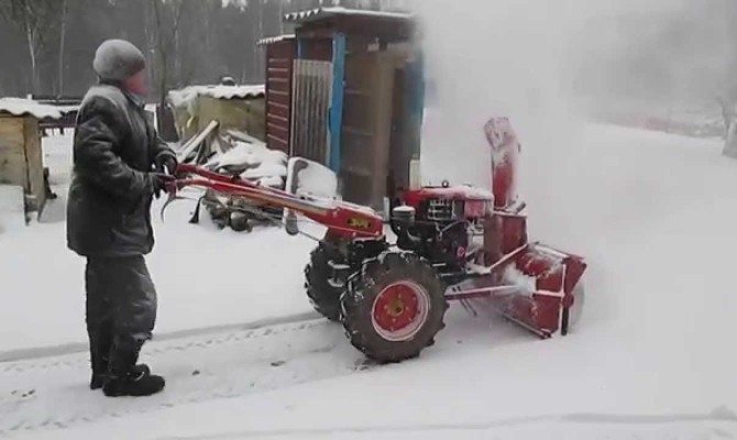 Snow removal with a walk-behind tractor